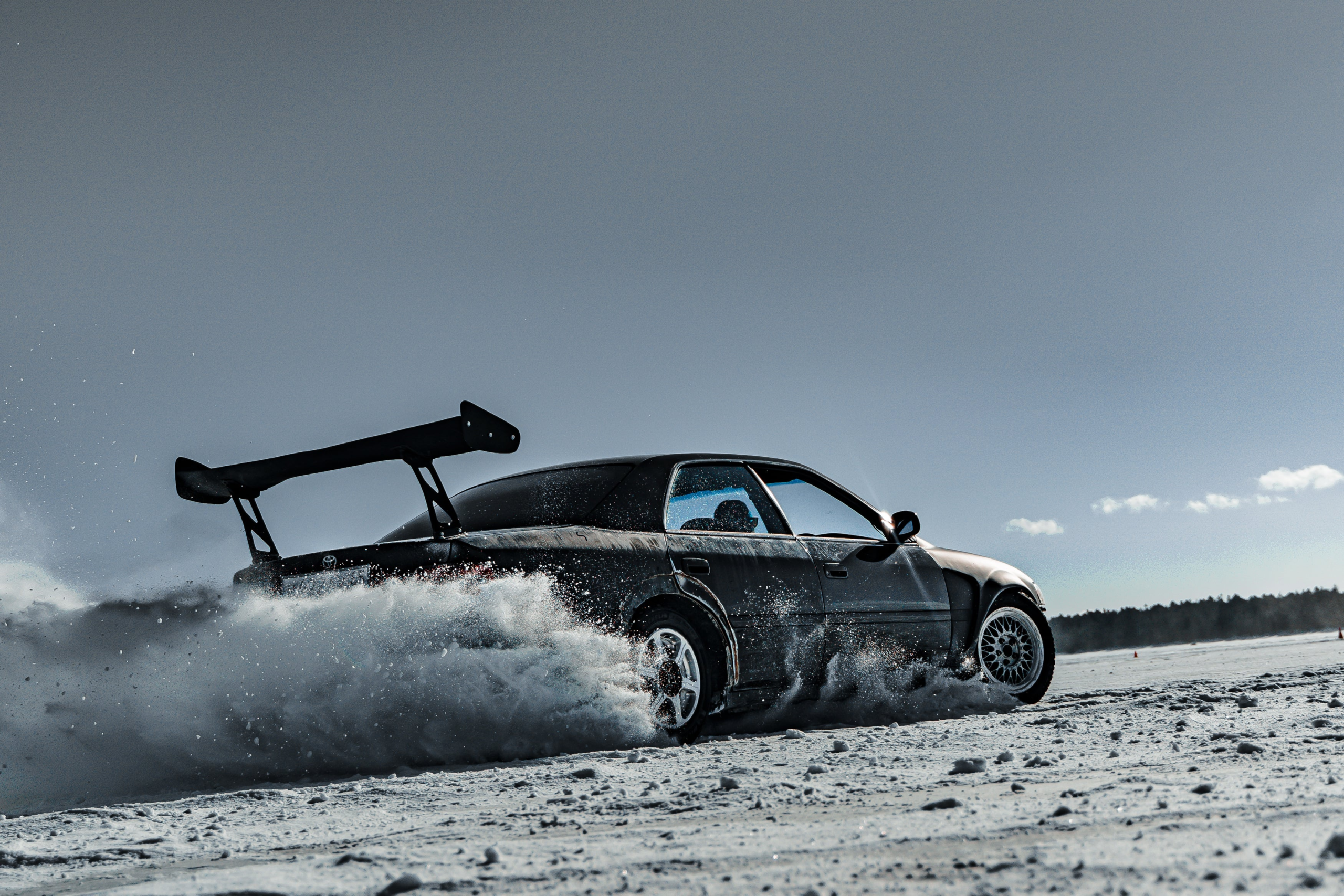Car drifting on snow showcasing KM+ performance
